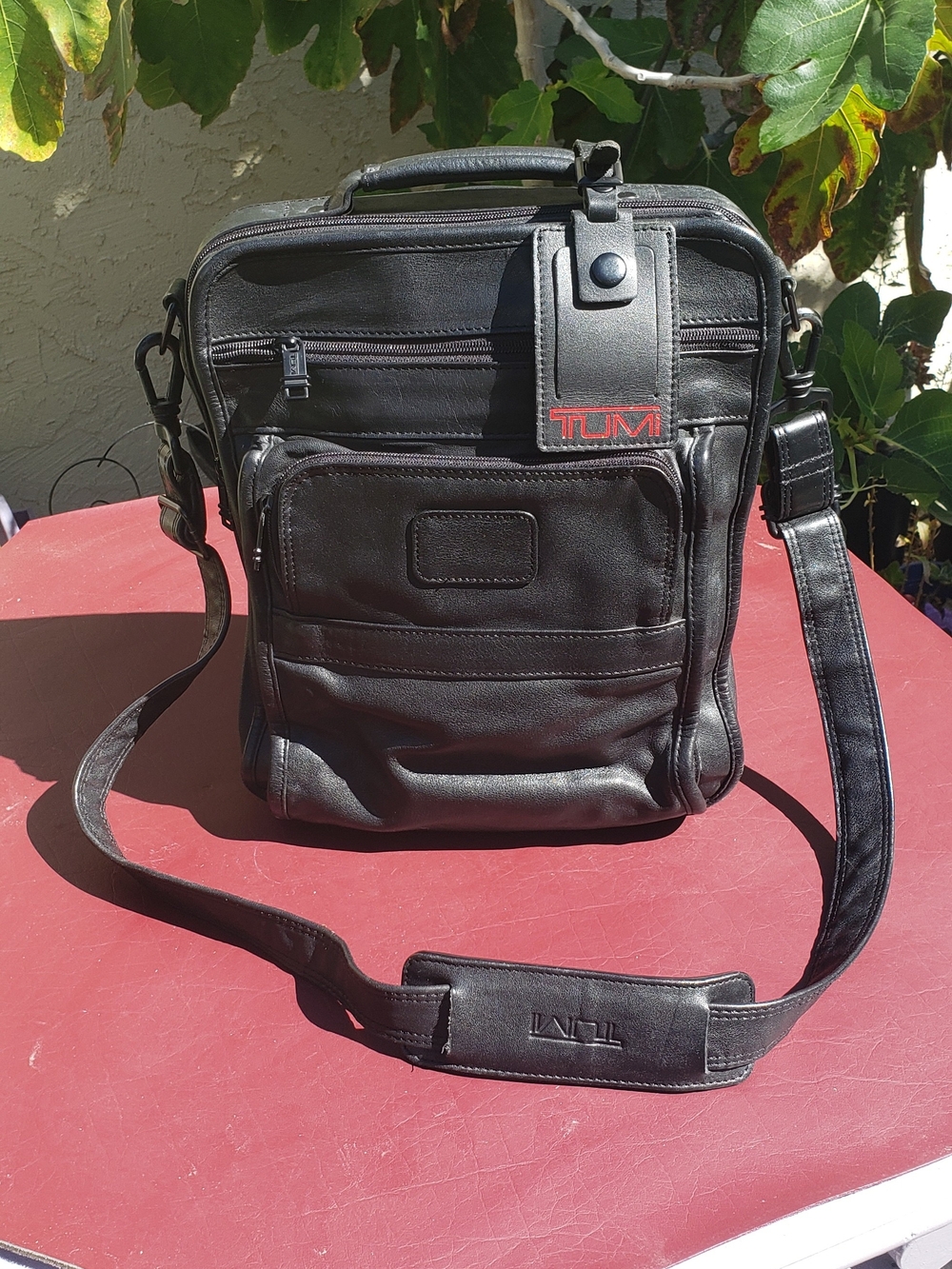 Tumi Black Leather Vertical Messenger Bag with Red Logo. Please See Pictures